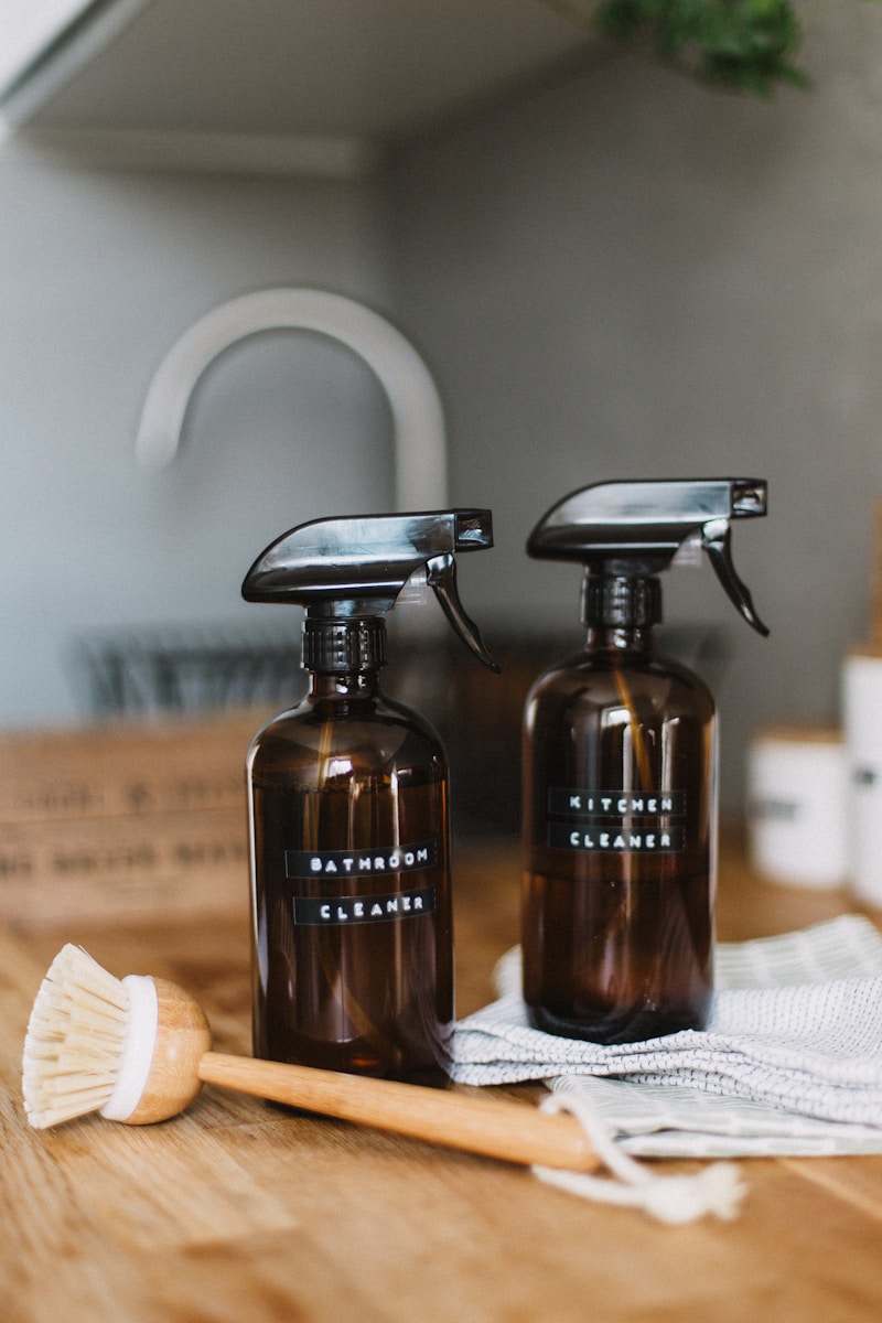 Best Tips For An Eco Friendly Kitchen. 2 brown spray bottles on brown table